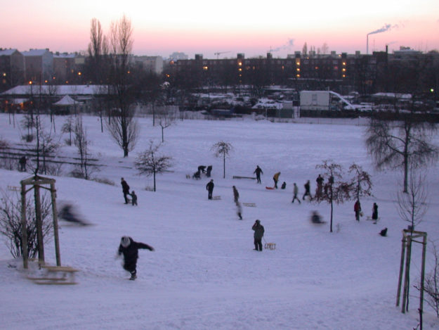 Berlin winter: people riding their sledge sle Mauerpark Prenzlauer Berg